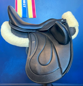 17" DMK Pinnacle Dressage Saddle with carbon fiber flap inlay & cantle infill, and carbon fiber seat facings. Curved Tree. High thigh, high profile blocks. Rent, Buy Demo, or Purchase New at Delfina Saddlery