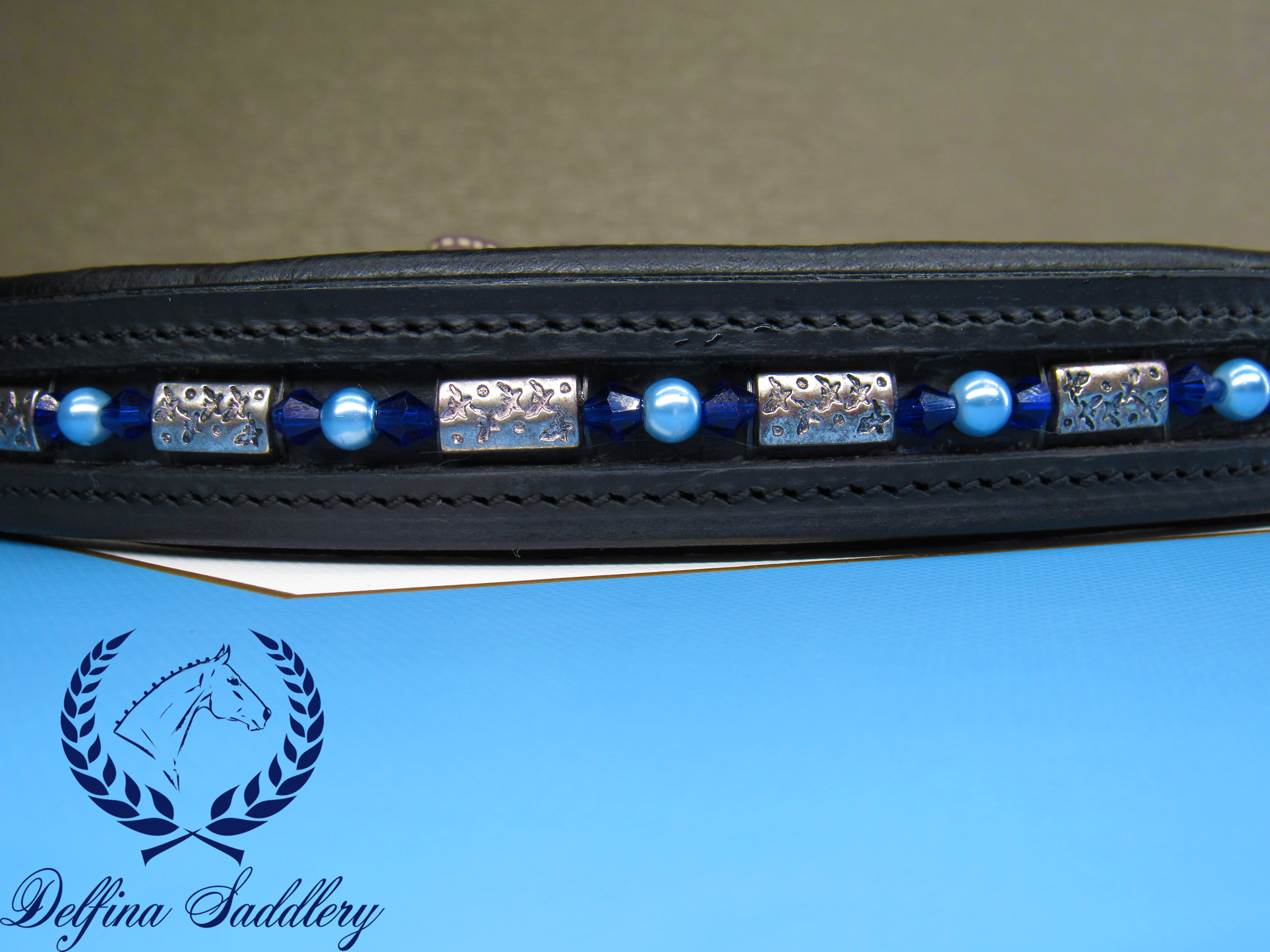 bright blue bicone crystals, sky blue pearls, and steel shark print beads custom browband for horse dressage hunter/jumper made by a veteran