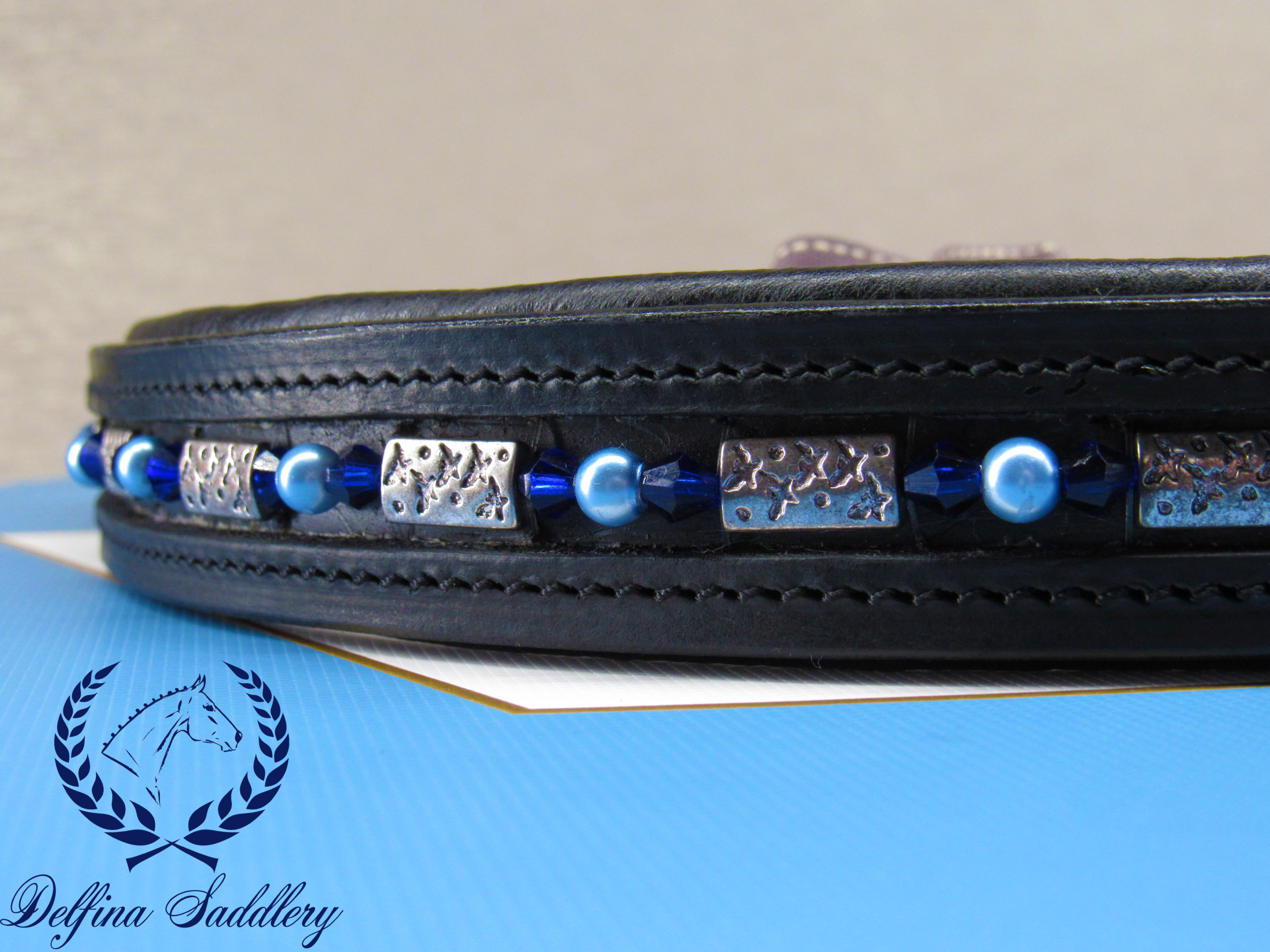 bright blue bicone crystals, sky blue pearls, and steel shark print beads custom browband for horse dressage hunter/jumper made by a veteran