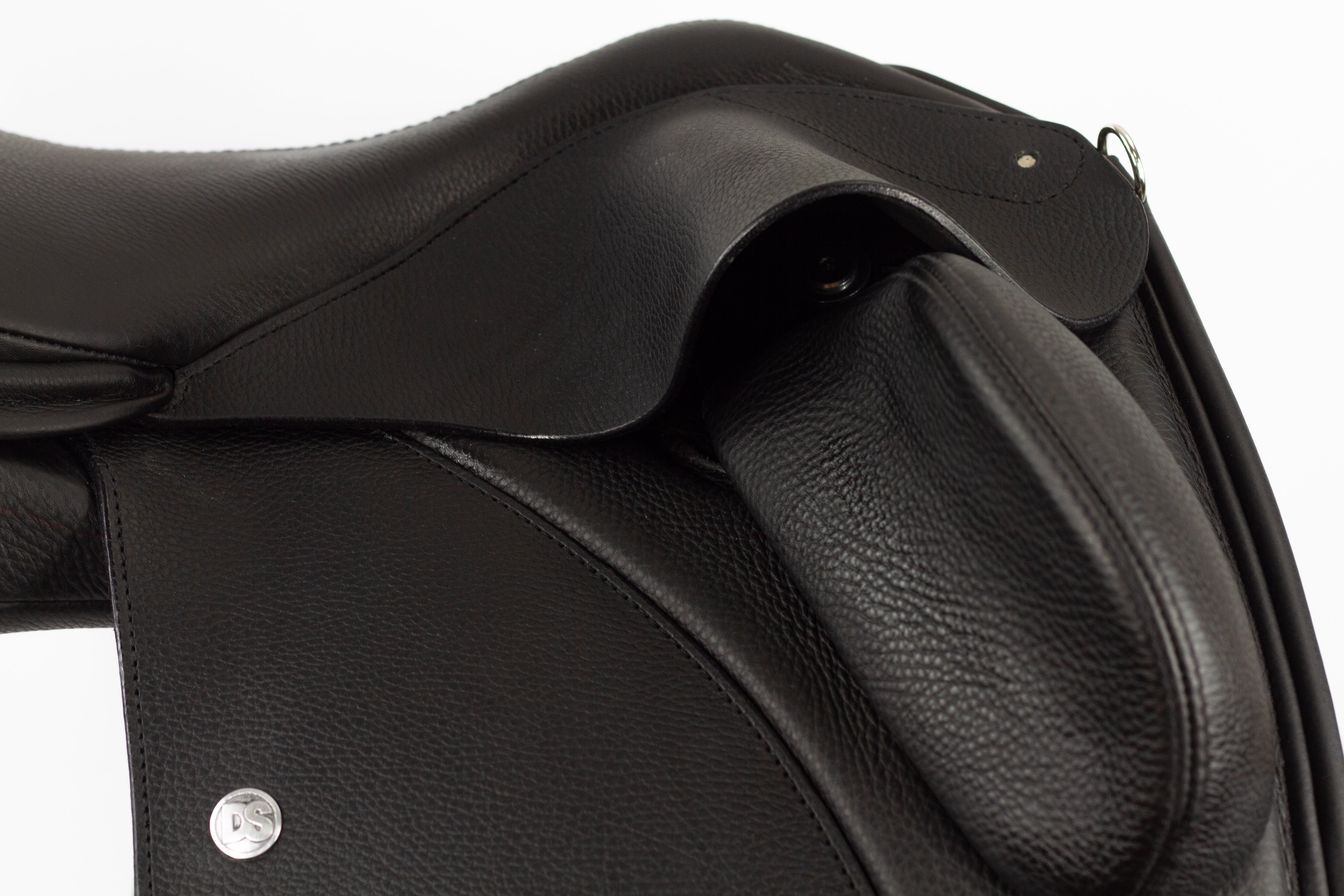 A close-up of the Duskin Dressage Saddle's adjustable fixed thigh block