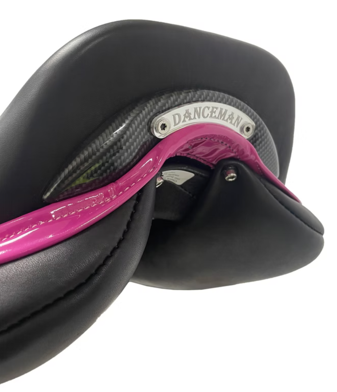 Signature Competitor Jumping Fixed Block + CB Saddle from WOW magenta facings close-up showing carbon fiber cantle plate and installed perspex name plate